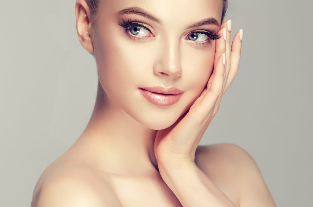 Beautiful Young Woman with Clean Fresh Skin look away .Girl beauty face care. Facial treatment