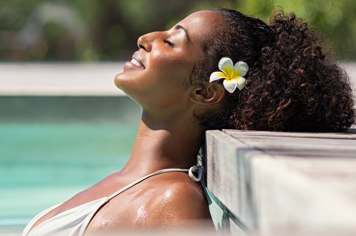 Beautiful african woman in pool relaxing