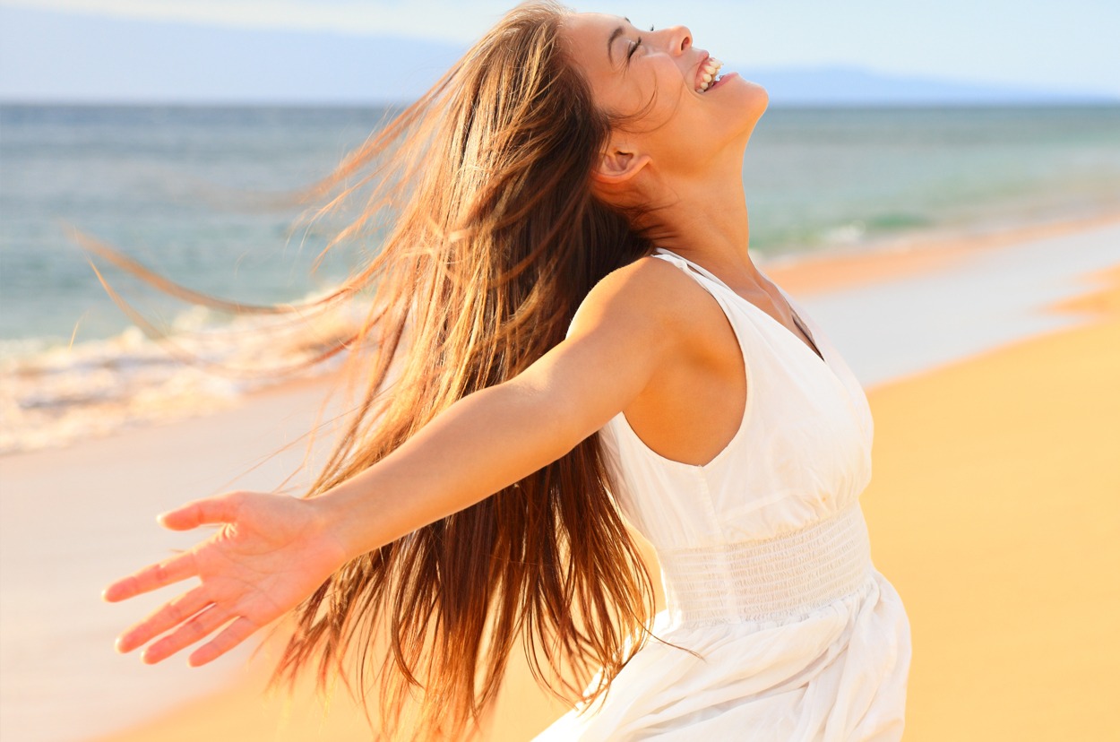 Free happy woman on beach