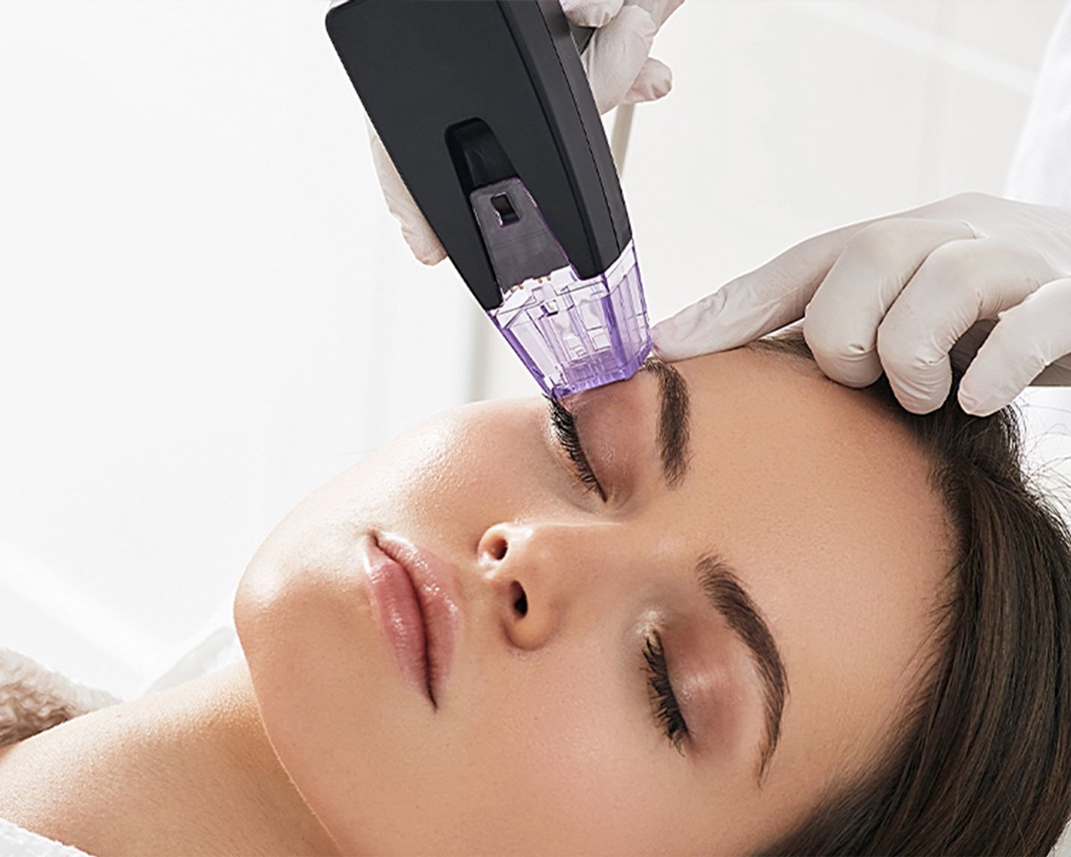 Woman receiving facial treatment.